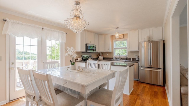 1411 Shenstone Dr, Harrisonburg, VA 22802 - kitchen featuring stainless steel appliances, light wood-style floors, dark countertops, pendant lighting, and white cabinets