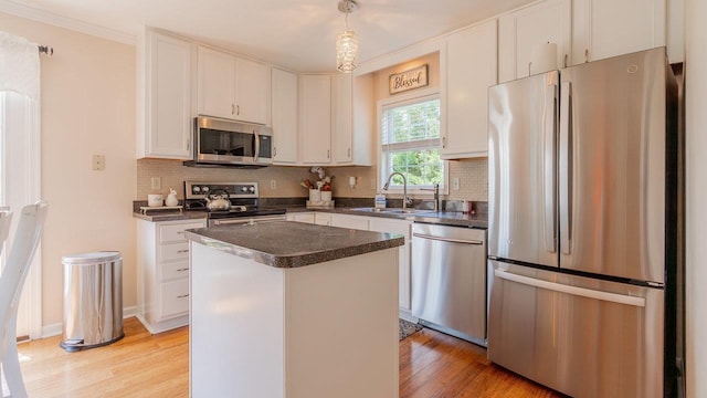 1411 Shenstone Dr, Harrisonburg, VA 22802 - kitchen featuring appliances with stainless steel finishes, dark countertops, light wood-style floors, and backsplash