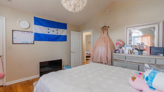 1411 Shenstone Dr, Harrisonburg, VA 22802 - bedroom featuring wood finished floors, vaulted ceiling, and a chandelier