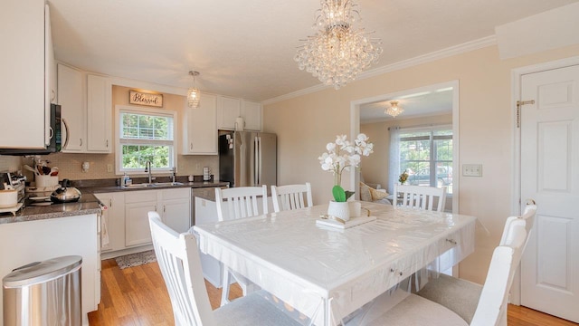 1411 Shenstone Dr, Harrisonburg, VA 22802 - dining room featuring plenty of natural light, light wood finished floors, ornamental molding, and a chandelier
