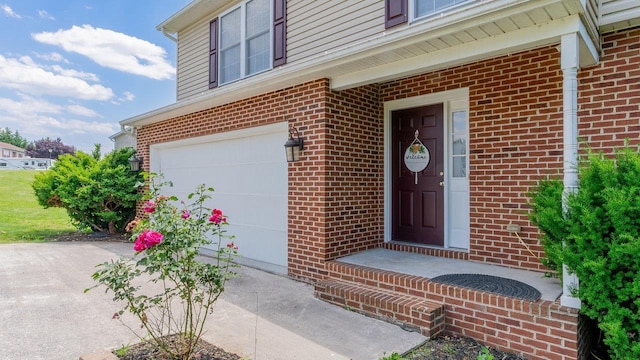1411 Shenstone Dr, Harrisonburg, VA 22802 - doorway to property with an attached garage, brick siding, and concrete driveway