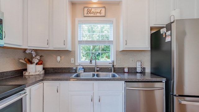 1411 Shenstone Dr, Harrisonburg, VA 22802 - kitchen with appliances with stainless steel finishes, white cabinetry, dark countertops, and decorative backsplash