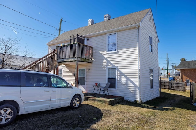 back of house featuring a yard