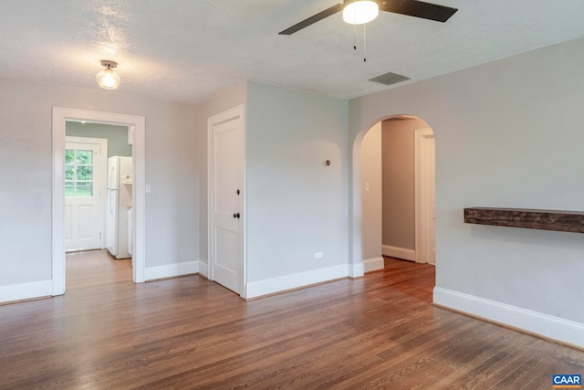 1014 Saint Charles Ave, Charlottesville, VA 22901 - spare room with wood finished floors, arched walkways, and a ceiling fan