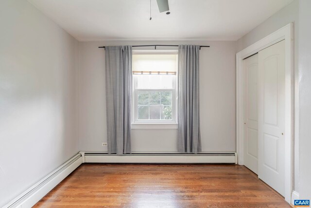 1014 Saint Charles Ave, Charlottesville, VA 22901 - unfurnished bedroom featuring baseboard heating, light wood finished floors, and a closet
