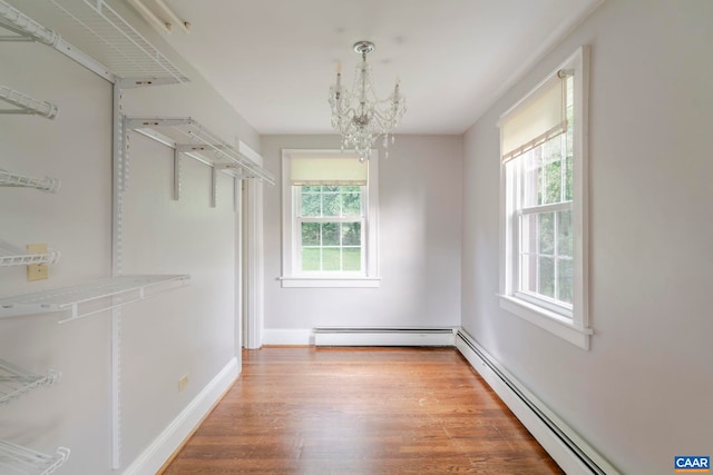 1014 Saint Charles Ave, Charlottesville, VA 22901 - spacious closet with a baseboard radiator, a chandelier, and wood finished floors