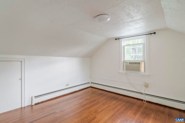 1014 Saint Charles Ave, Charlottesville, VA 22901 - bonus room with a baseboard radiator, wood finished floors, lofted ceiling, a textured ceiling, and cooling unit