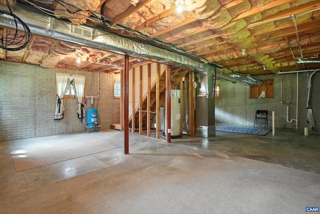 2070 Woodson Rd, Nelson, VA 22967 - basement featuring water heater, a water pressure tank, stairway, brick wall, and heating unit