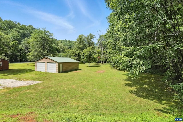 2070 Woodson Rd, Nelson, VA 22967 - view of grassy yard featuring a detached garage and an outbuilding