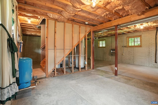 2070 Woodson Rd, Nelson, VA 22967 - basement with a water pressure tank, water heater, brick wall, heating unit, and stairs
