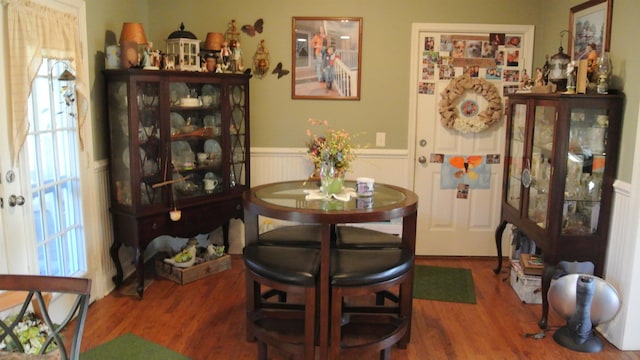 dining room featuring a wainscoted wall and wood finished floors