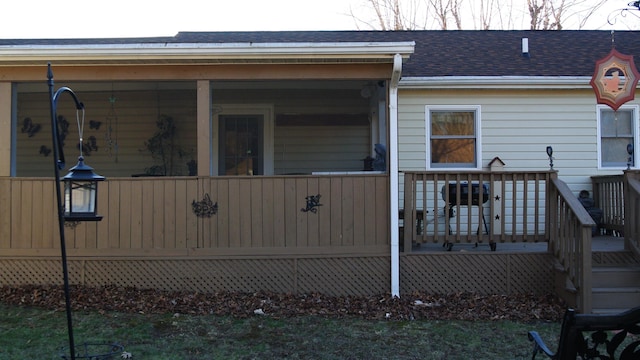 back of property featuring a shingled roof