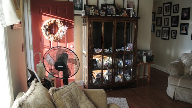 living room featuring an inviting chandelier, baseboards, and wood finished floors