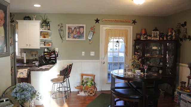 dining room featuring wood finished floors and wainscoting