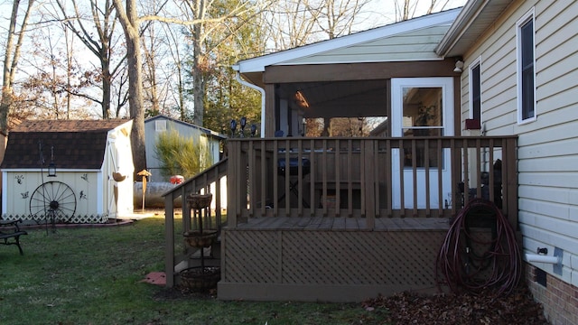 deck featuring an outbuilding, a yard, and a shed