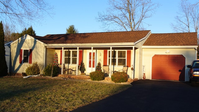 single story home with driveway, a shingled roof, an attached garage, a porch, and a front yard