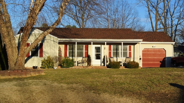 ranch-style house featuring covered porch, a front lawn, and an attached garage