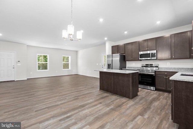 27000 Tatum Rd, Unionville, VA 22567 - kitchen featuring stainless steel appliances, a kitchen island, a chandelier, dark brown cabinets, and wood finished floors