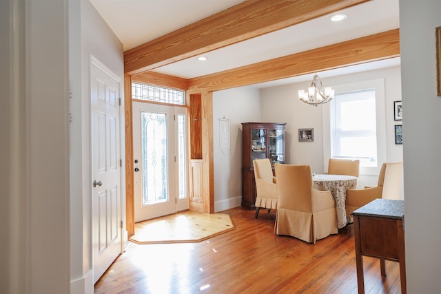 foyer featuring a chandelier, recessed lighting, beamed ceiling, and light wood-style floors
