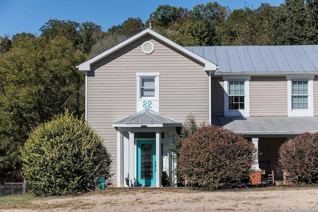 traditional home featuring metal roof and a standing seam roof