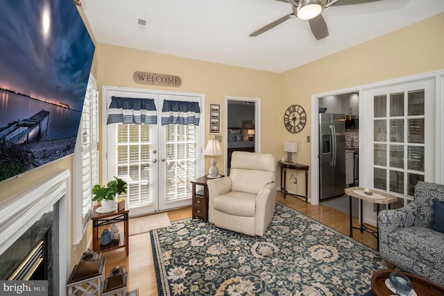 9404 Dalmahoy Ln, Fredericksburg, VA 22408 - living area with french doors, ceiling fan, wood finished floors, and a fireplace