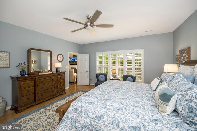 9404 Dalmahoy Ln, Fredericksburg, VA 22408 - bedroom with wood finished floors, baseboards, and a ceiling fan