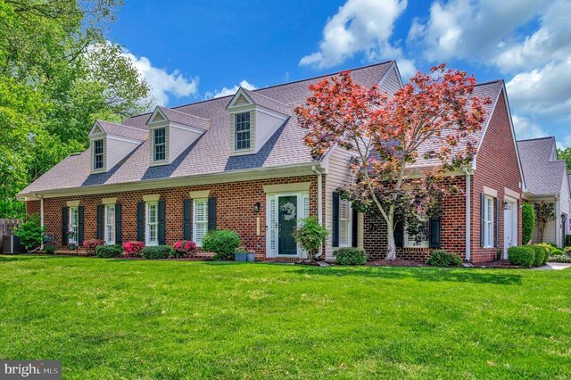 9404 Dalmahoy Ln, Fredericksburg, VA 22408 - cape cod-style house with brick siding, a front lawn, and roof with shingles