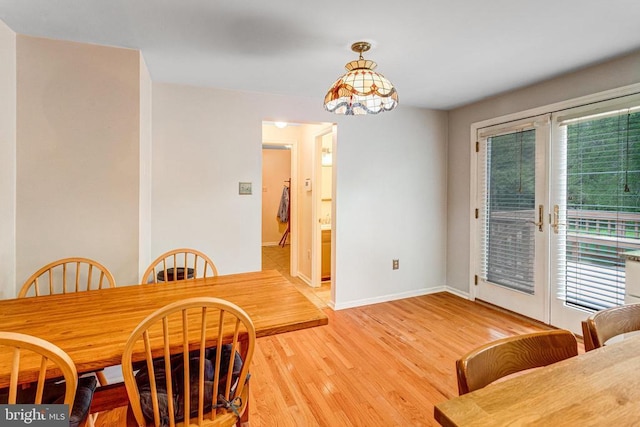  - dining room with light wood-style flooring and baseboards