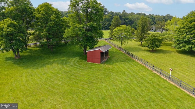  - view of yard featuring an outbuilding and a view of rural / pastoral area