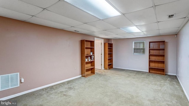  - unfurnished room featuring a drop ceiling and carpet