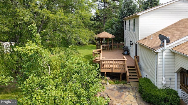  - view of yard featuring a gazebo, a deck, and view of wooded area