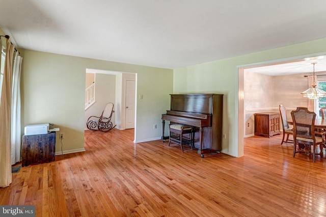  - living room featuring wood finished floors and a chandelier