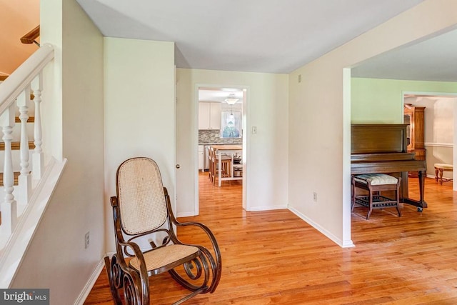  - corridor with stairway and light wood-style flooring