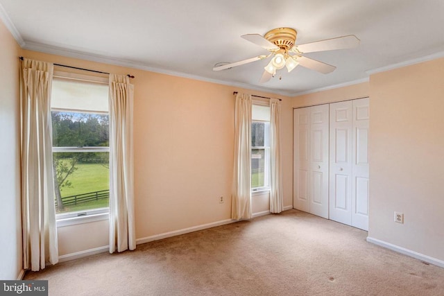  - unfurnished bedroom with carpet flooring, ornamental molding, a ceiling fan, and a closet