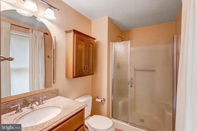  - bathroom featuring a stall shower and vanity