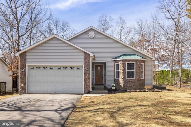 view of front of home featuring aphalt driveway, stone siding, and a garage