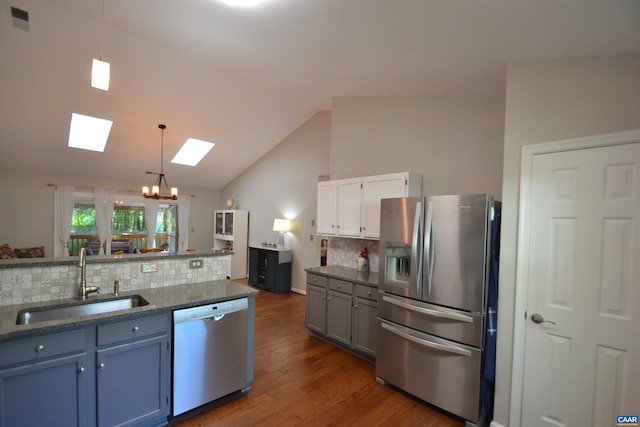 2090 Tavernor Ln, Charlottesville, VA 22911 - kitchen with dishwashing machine, stainless steel fridge, a skylight, tasteful backsplash, and dark wood-type flooring