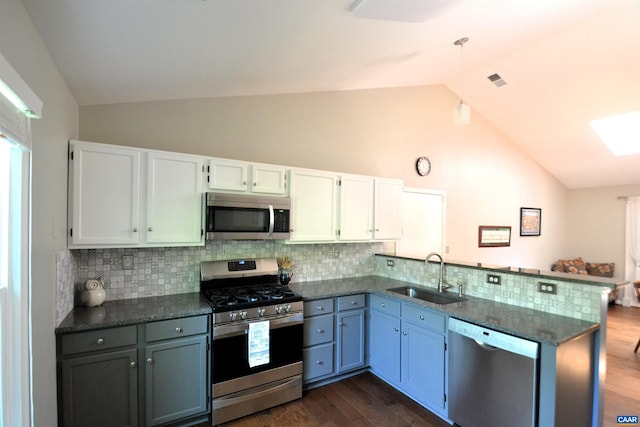 2090 Tavernor Ln, Charlottesville, VA 22911 - kitchen with appliances with stainless steel finishes, a peninsula, dark wood finished floors, decorative backsplash, and white cabinetry