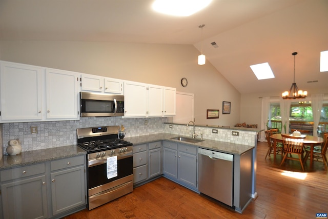 2090 Tavernor Ln, Charlottesville, VA 22911 - kitchen with appliances with stainless steel finishes, a chandelier, gray cabinets, a peninsula, and a skylight