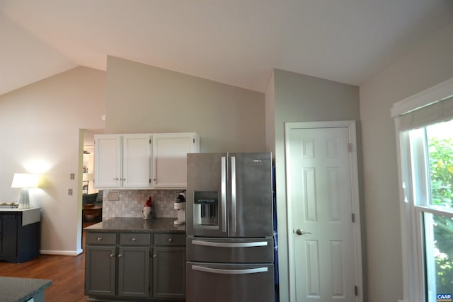 2090 Tavernor Ln, Charlottesville, VA 22911 - kitchen with stainless steel refrigerator with ice dispenser, vaulted ceiling, white cabinetry, backsplash, and dark wood-type flooring