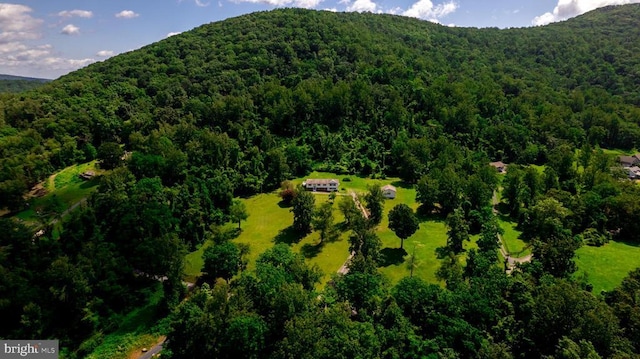  - aerial view of property's location featuring a forest and mountains