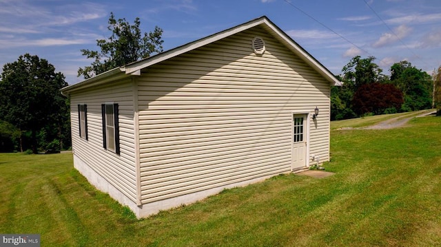  - view of side of home featuring a yard