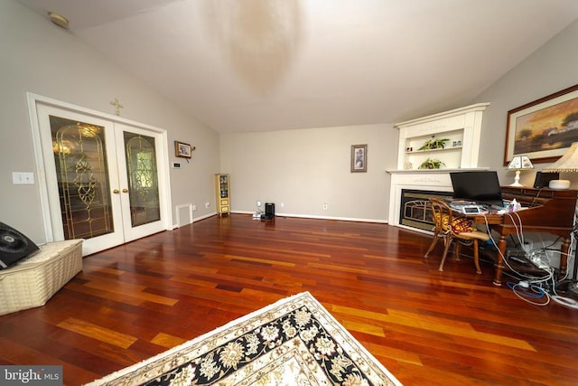  - home office featuring french doors, wood finished floors, a fireplace, and lofted ceiling