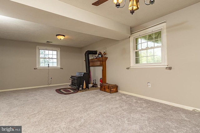  - interior space with a wood stove and carpet floors