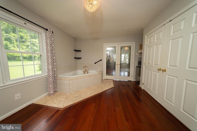  - foyer with plenty of natural light, wood finished floors, and french doors