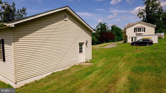  - view of side of home featuring a lawn