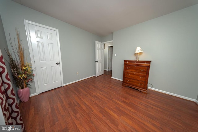  - bedroom featuring wood finished floors and baseboards