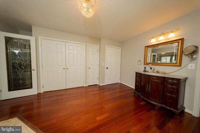  - bedroom featuring dark wood-style floors and a closet