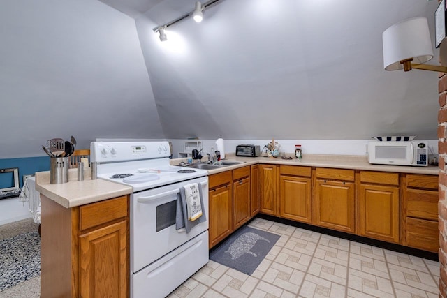 289 Newman Ave, Harrisonburg, VA 22801 - kitchen with white appliances, rail lighting, light countertops, vaulted ceiling, and a peninsula