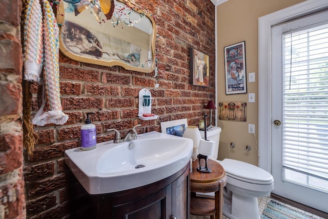 289 Newman Ave, Harrisonburg, VA 22801 - bathroom featuring brick wall, toilet, and vanity